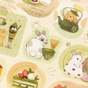 May include: A repeating pattern featuring cartoon bunnies with matcha tea and desserts. The illustrations include a bunny with a whisk and matcha, a bunny in a teapot, and a matcha parfait. The colour palette is soft, with greens, browns, and whites.