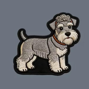 May include: An embroidered patch featuring a gray and white Schnauzer dog standing in profile. The dog has a textured coat, a bushy white beard, curly fur on its head, and wears a thin orange collar. The entire design is outlined in black.