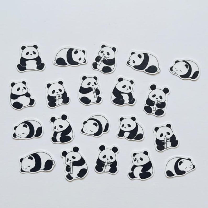 May include: A collection of twenty individual die-cut stickers featuring black and white illustrations of pandas in various poses, including sitting, sleeping, and holding bamboo stalks, arranged in a grid pattern on a plain white background.