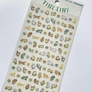 May include: A sheet of Tiny Tiny stickers featuring various cartoon tiger illustrations in orange, yellow, green, and white. The stickers are in different poses and sizes, with the text "TINY TINY" at the top.