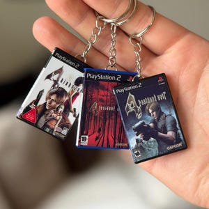 Llavero con forma de estuche de juego de Resident Evil 4 para PS2 – Versiones Biohazard 4 y RE4 – Mini llavero de juego de PlayStation 2 – Regalo para gamers