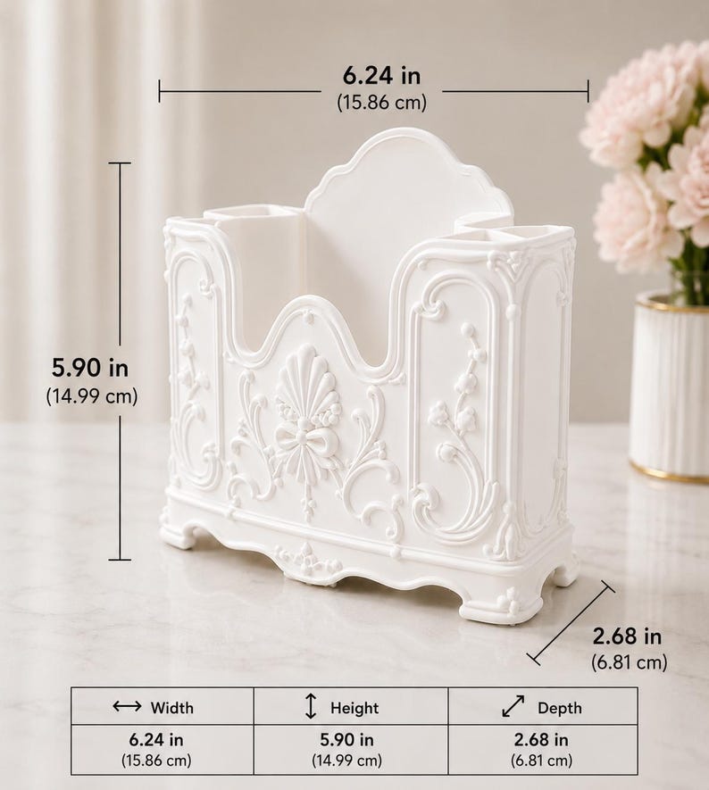 May include: A white desk organizer featuring ornate relief detailing, including a central shell and bow motif. It measures 6.24 inches in width, 5.90 inches in height, and 2.68 inches in depth, with multiple compartments for storage and a raised back panel.