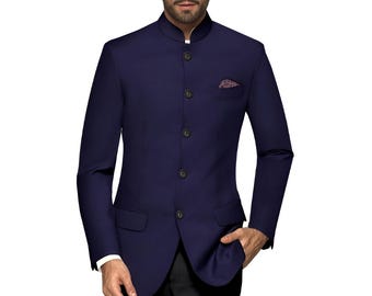 May include: A navy blue band collar suit jacket with matching black dress pants. The jacket has a pocket square and buttoned closure. The outfit is completed with black dress shoes. A stylish formal ensemble.