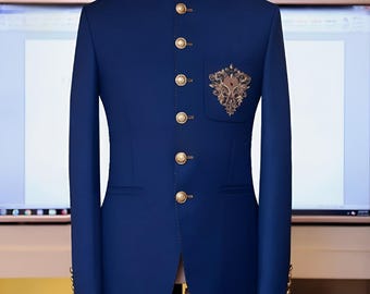 May include: A navy blue blazer with a mandarin collar and gold buttons. The blazer features an embroidered design on the chest pocket. The sleeves have gold buttons at the cuffs. The jacket is displayed on a mannequin.