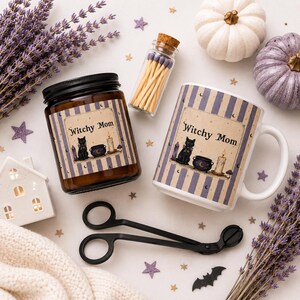 May include: A brown glass candle jar and a white ceramic mug, both featuring a label with the text Witchy Mom, a black cat, a cauldron, and a candle. Includes a small glass bottle of matches, black metal wick trimmers, lavender, and pumpkins.