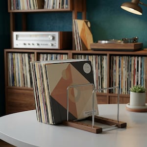 May include: A handmade, wooden cutting board with a natural finish. The board features a live edge on one side and a smooth, rectangular shape. It is approximately 18 inches long and 12 inches wide.