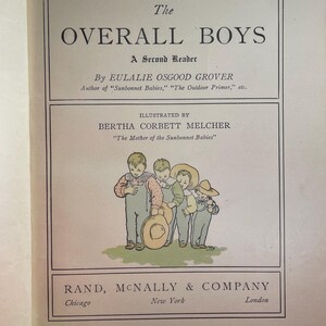 May include: Open book with the title "The Overall Boys" and illustrations of children. The book is a second reader by Eulalie Osgood Grover, illustrated by Bertha Corbett Melcher, and published by Rand, McNally & Company.