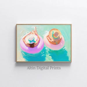 May include: A framed print of two people relaxing in the water on pink inflatable rings. They are wearing sun hats with colorful ribbons. The water is a mix of turquoise and light blue. The print is labeled "Altin Digital Prints".