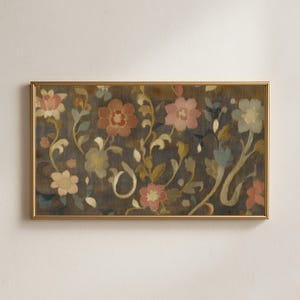 May include: A framed floral artwork featuring a dark background with a pattern of stylized flowers in shades of pink, peach, and blue. The flowers are connected by curving stems and leaves in muted green and yellow tones. The frame is gold.