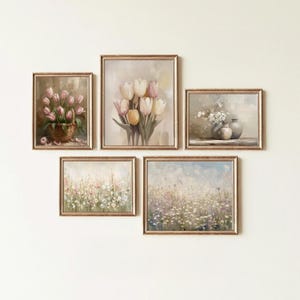 May include: A collection of five framed floral art prints. The prints feature various flower arrangements, including tulips in a basket and a vase, and fields of wildflowers. The frames have a gold finish, and the artwork has a soft, pastel color palette.