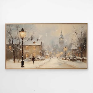 May include: An oil painting in a gold frame shows a snowy street scene. Buildings with lit windows are illuminated by street lamps. A figure walks down the snowy path, with a church steeple in the distance. The artwork evokes a winter atmosphere.