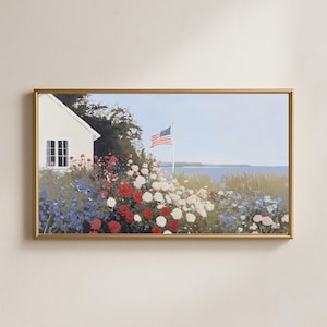 May include: A framed painting depicts a coastal scene with a white house, an American flag, and a vibrant flower garden. The garden features red, white, and blue flowers, with a blue ocean and sky in the background.