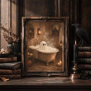 May include: A framed wall art print depicting a white ghost with two black eyes sitting in a clawfoot bathtub filled with bubbles and steam. The scene is set in a dimly lit, rustic bathroom with wooden walls, shelves, and warm ambient lighting.