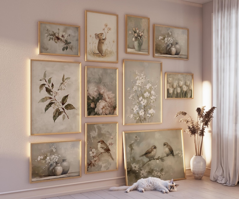 May include: A collection of framed botanical and animal art prints in a variety of sizes. The prints feature soft, muted colors and depict flowers, birds, and a mouse. The frames are gold-toned, and the overall aesthetic is vintage and elegant.