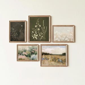May include: A collection of five framed botanical art prints. The prints feature floral and landscape scenes in muted tones of green, beige, and pink. The frames have a gold finish, and the artwork is arranged on a white wall.