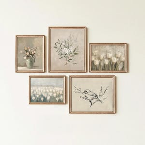 May include: A collection of five framed art prints with gold-colored frames. The prints feature floral and botanical themes, including tulips, a vase of flowers, and a bird on a branch. The color palette is soft, with muted tones of beige, green, and white.