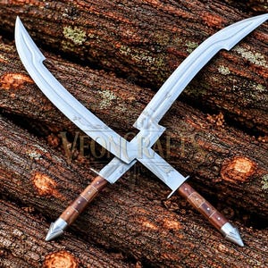 May include: Two crossed swords with curved silver blades and brown wooden handles featuring metal accents. The blades have a distinct notch near the hilt and engraved details. The text VEON CRAFTS is visible in the centre of the crossed blades.