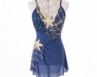 May include: A navy blue sleeveless dress featuring a sheer overlay, adorned with a cream-coloured rope net, two embellished starfish appliqués, and scattered blue and silver sequins. The garment is displayed on a mannequin with the text Alissa Creates.