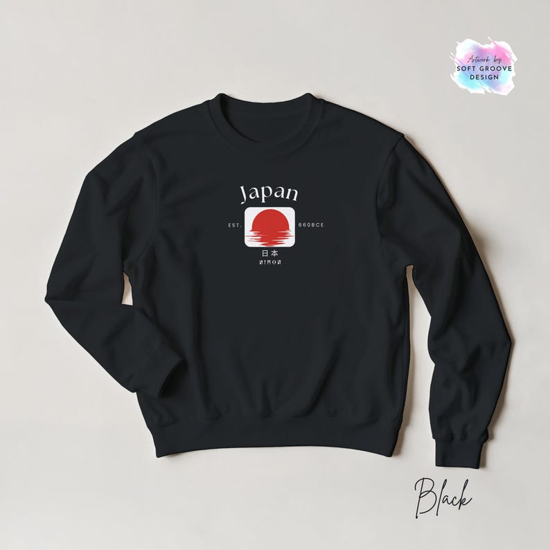 May include: Black sweatshirt featuring a graphic of the Japanese flag with the word "Japan" above a red sun design. The sweatshirt also includes the text "EST 660BCE" and Japanese characters. The word "Black" is written in cursive at the bottom.