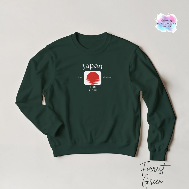 May include: Forrest Green sweatshirt with a graphic design featuring the word "Japan" above a red sun emblem. The design includes Japanese characters and the text "EST. 1980s". The sweatshirt is a solid color.