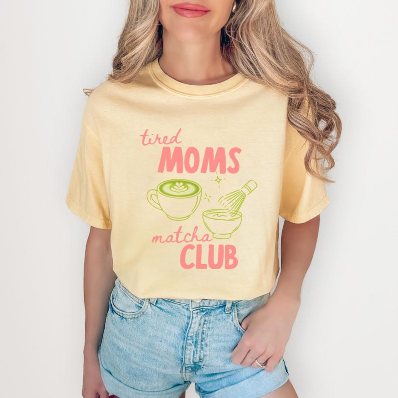 Matcha themed mom shirt with tired moms matcha club text featuring cup and whisk illustration in soft aesthetic on cotton tee