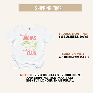 May include: White crew neck t-shirt featuring the text "tired MOMS matcha CLUB" in pink and green. The design includes a matcha latte and whisk. A casual top.