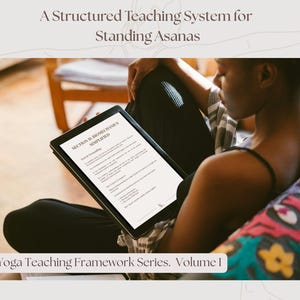 May include: A person is seated, reading a tablet with the text "SECTION II BIOMECHANICS SIMPLIFIED". The tablet is held in the lap, with the text "The Yoga Teaching Framework Series. Volume 1" at the bottom. The background includes a chair and a colorful pillow.