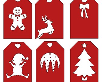 May include: Six red gift tags with white cut-out designs. The designs include a gingerbread man, a reindeer, a bow, an elf, a moon with trees, and a Christmas tree. Each tag has a hole at the top for stringing.