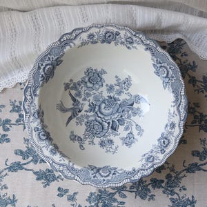 Puede incluir: Una bandeja de servir de madera hecha a mano con acabado natural. La bandeja es rectangular, con bordes elevados y asas integradas. La veta de la madera es visible. Dimensiones: aprox. 40 cm de largo y 25 cm de ancho.