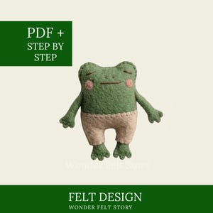 May include: A green felt frog doll with pink cheeks and beige trousers, featuring stitched eyes and mouth. The image includes text that reads PDF + STEP BY STEP and FELT DESIGN WONDER FELT STORY on dark green rectangular banners.