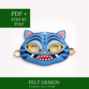 May include: A blue felt tiger mask with yellow eyes, white fangs, and a red mouth, featuring gold elastic straps. The image includes the text "PDF + STEP BY STEP" and "FELT DESIGN WONDER FELT STORY".