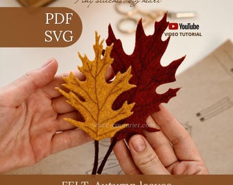 May include: Two felt autumn leaves in mustard yellow and deep burgundy with dark brown stems. The image includes text: Tiny stitches, big heart, PDF, SVG, YouTube VIDEO TUTORIAL, FELT Autumn leaves, WONDER FELT STORY, and white-couturier.com.