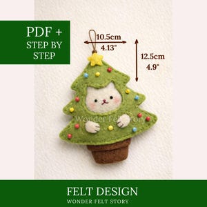May include: A green felt Christmas tree ornament with a cat face, measuring 4.13 inches wide and 4.9 inches tall. The ornament has colorful bead accents and a brown pot base. Text on the image reads "FELT DESIGN" and "WONDER FELT STORY".