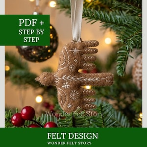 May include: A brown felt bird ornament featuring white embroidered star and chevron patterns, suspended by a beige ribbon. The text PDF + STEP BY STEP and Wonder Felt Story FELT DESIGN WONDER FELT STORY is visible on the image overlay.