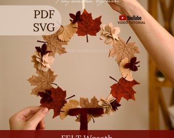 May include: A circular felt wreath featuring assorted autumn-colored leaves in shades of brown, tan, and deep red, accented with small fabric flowers and a dark red ribbon bow at the bottom. Text includes "Tiny stitches, big heart", "PDF SVG", "YouTube VIDEO TUTORIAL", "white-couturier.com", "FELT Wreath", and "WONDER FELT STORY".