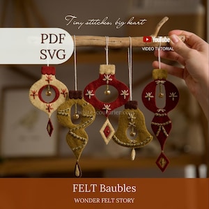 May include: Five felt ornaments in red, cream, and olive green hanging from a wooden branch. The ornaments feature embroidered details, small metallic bells, and geometric shapes. Text on the image includes "Tiny stitches, big heart", "PDF SVG", "YouTube VIDEO TUTORIAL", "white-couturier.com", "FELT Baubles", and "WONDER FELT STORY".
