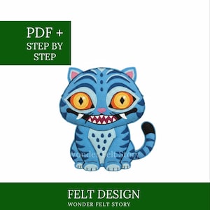 May include: A blue felt cat design with orange eyes and a toothy grin. The design includes the text "PDF + STEP BY STEP" and "FELT DESIGN WONDER FELT STORY".