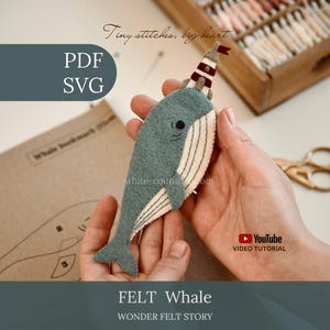 May include: A felt narwhal craft project featuring a blue-grey body with a cream-coloured belly, a small black eye, and a striped lighthouse-shaped horn on its head. The text reads Tiny stitches, big heart, PDF, SVG, YouTube VIDEO TUTORIAL, FELT WHALE, WONDER FELT STORY.