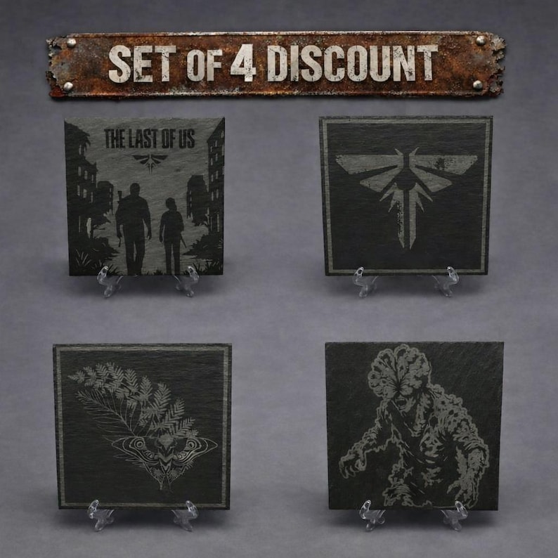 May include: A set of four square black slate coasters featuring engraved designs from The Last of Us, including the game title, a firefly logo, a moth with a fern, and a clicker creature. Each coaster rests on a small clear plastic stand.