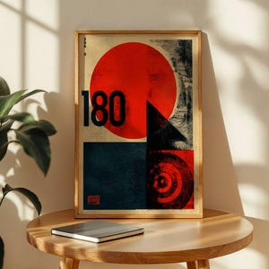 May include: A framed art print with a striking geometric composition. The artwork showcases a large red circle, a black triangle, and the number "180" in black. A dark blue square and a target design are also included. The print is in a wooden frame.