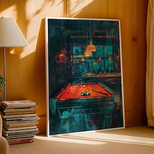 Op de afbeelding: Een ingelijste kunstdruk met een biljarthalscène. Het kunstwerk toont een rode pooltafel, hangende lichten en een bar in tinten van teal, rood en zwart. De print leunt tegen een houten muur.