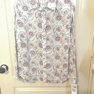 May include: A white button-down shirt with a floral pattern in shades of red, brown, and blue. The shirt has long sleeves and a collared neckline. The brand name "Pendleton" is visible on the label.