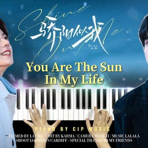May include: A promotional image for "Shine on Me" featuring a piano keyboard with the text "You Are The Sun In My Life." The image includes two people, one on each side of the piano, with a blue background and text in both English and Chinese.