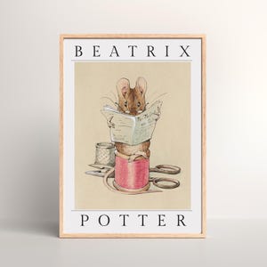 May include: A framed print depicting a brown mouse reading a newspaper titled "The Tailor and Cutter" atop a pink thread spool. A thimble and scissors are also present. The print is labelled "BEATRIX POTTER".