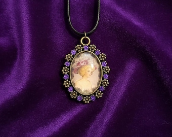 Vintage-style oval cameo pendant necklace with purple rhinestone accents on a black cord