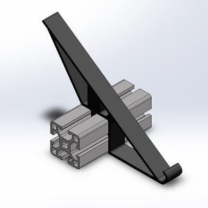 May include: A black plastic hook bracket attached to a grey aluminium T-slot extrusion profile. The bracket features a triangular support structure with a curved hook at the bottom end, designed to mount onto the grooved metal beam section.