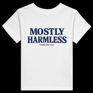 Könnte beinhalten: Weißes T-Shirt mit dem marineblauen Text "MOSTLY HARMLESS" und dem kleineren Text "*results may vary" darunter. Das T-Shirt hat kurze Ärmel und einen Rundhalsausschnitt.