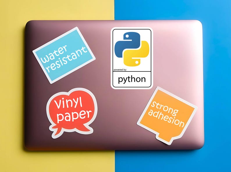 May include: A laptop with four stickers. One sticker has the Python logo and the word "python". Other stickers say "water resistant", "vinyl paper", and "strong adhesion". The laptop is on a yellow and blue background.