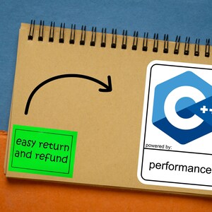 May include: A spiral-bound notepad with a pen, a green sticker with the text "easy return and refund", and a sticker with a blue and white logo and the word "performance". A black arrow is drawn on the notepad.