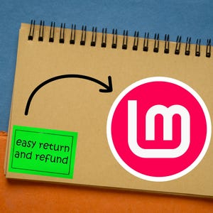 May include: A wooden pen with gold accents rests beside a spiral-bound notepad. The notepad features a pink and white logo and a green sticker with the text "easy return and refund". A black arrow points to the logo.